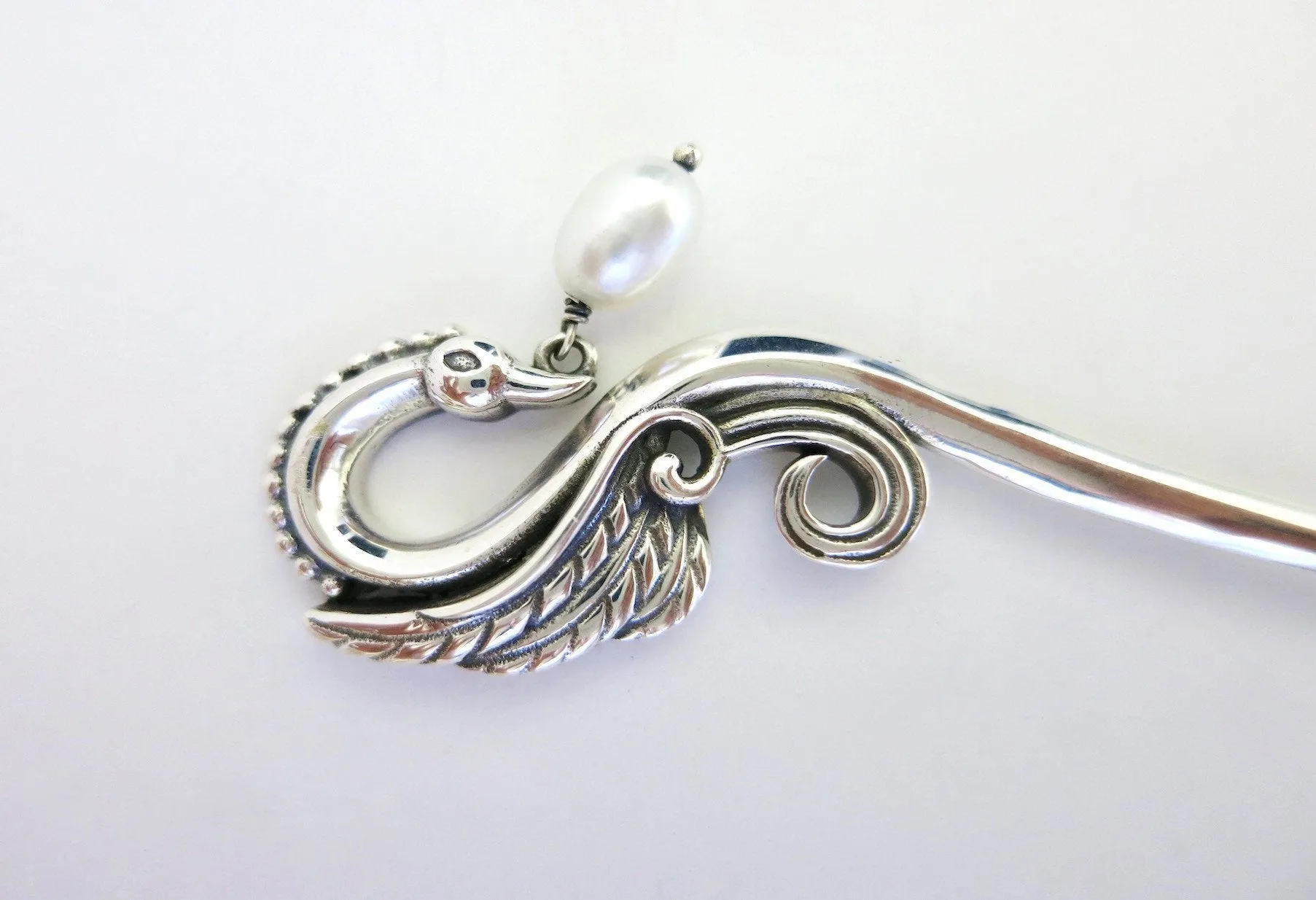 Graceful, swan bun-stick with a dangling pearl