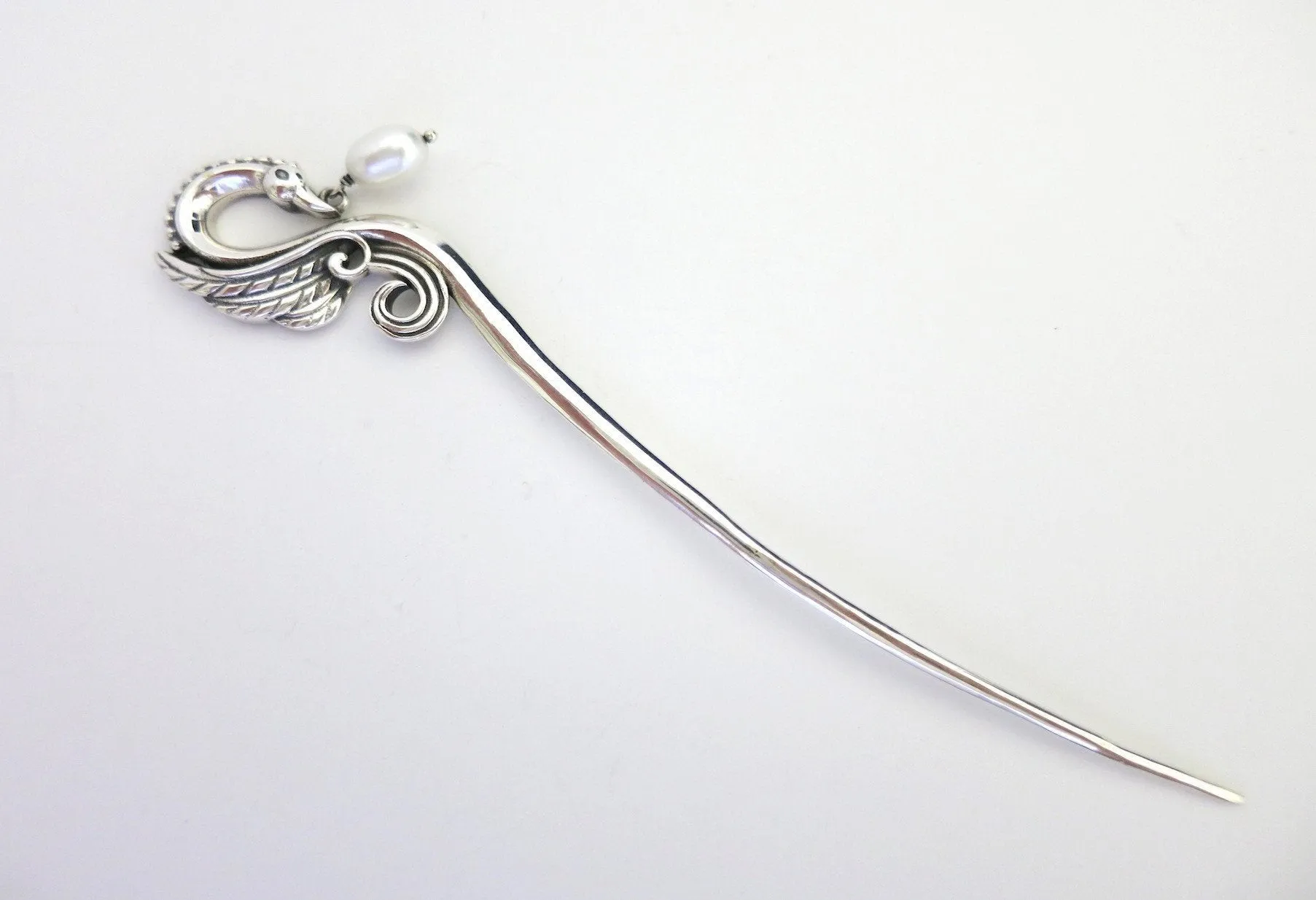 Graceful, swan bun-stick with a dangling pearl